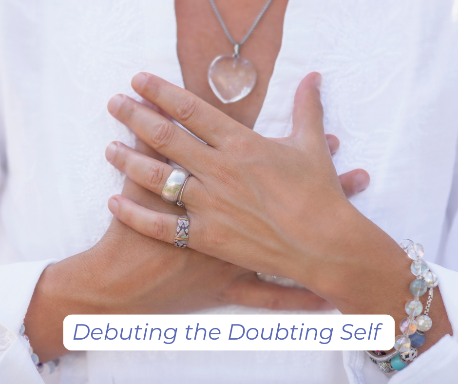 A woman with hands over her heart, debuting the doubting self