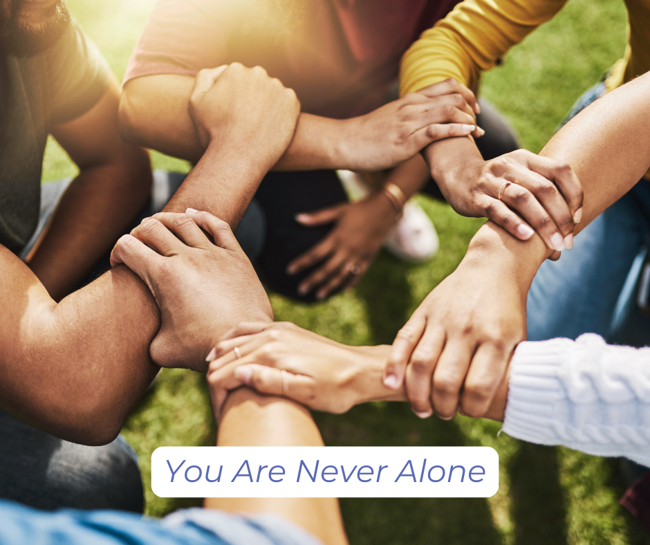 Group of people in a circle, each holding onto the arm of the person to their left, forming a strong bond.